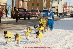 Wade Marrs runs down Front Street on the way to the Nome finish line on Wednesday March 18, 2015 during Iditarod 2015.  (C) Jeff Schultz/SchultzPhoto.com - ALL RIGHTS RESERVED DUPLICATION  PROHIBITED  WITHOUT  PERMISSION