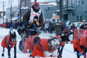Ken Anderson enters the Nome finish chute with his 6-year old son Leif riding the last way on Wednesday March 18, 2015 during Iditarod 2015.  (C) Jeff Schultz/SchultzPhoto.com - ALL RIGHTS RESERVED DUPLICATION  PROHIBITED  WITHOUT  PERMISSION