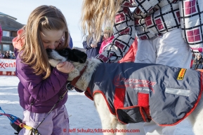 Ashley Perry, a close friend of Wade Marrs, hugs one of his dogs after his finish at the Nome finish line on Wednesday March 18, 2015 during Iditarod 2015.  (C) Jeff Schultz/SchultzPhoto.com - ALL RIGHTS RESERVED DUPLICATION  PROHIBITED  WITHOUT  PERMISSION