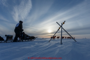 Ken Anderson runs past a tripod trail marker on the trail several miles from the Nome finish line near sunset on Wednesday March 18, 2015 during Iditarod 2015.  (C) Jeff Schultz/SchultzPhoto.com - ALL RIGHTS RESERVED DUPLICATION  PROHIBITED  WITHOUT  PERMISSION
