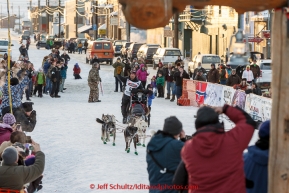 Aaron Burmeister and his son Hunter run into the finish chute in Nome in third place on Wednesday March 18, 2015 during Iditarod 2015.  (C) Jeff Schultz/SchultzPhoto.com - ALL RIGHTS RESERVED DUPLICATION  PROHIBITED  WITHOUT  PERMISSION