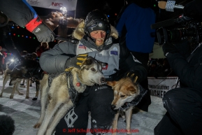 Dallas Seavey hugs his lead dogs Reef and Hero shortly after winning the 2015 Iditarod in 8 days 18 hours 13 minutes 6 seconds on Wednesday March 18, 2015  (C) Jeff Schultz/SchultzPhoto.com - ALL RIGHTS RESERVED DUPLICATION  PROHIBITED  WITHOUT  PERMISSION