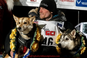 Dallas Seavey's dogs Reef and Hero recieve the garland of roses on the winner stand after Dallas won his 3rd Iditarod in 8 days 18 hours 13 minutes 6 seconds on Wednesday March 18, 2015 during Iditarod 2015.  (C) Jeff Schultz/SchultzPhoto.com - ALL RIGHTS RESERVED DUPLICATION  PROHIBITED  WITHOUT  PERMISSION