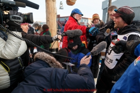 Radio and TV crews interview Aaron Burmeister shorlty after his arrival in third place at the Nome finish line on Wednesday March 18, 2015 during Iditarod 2015.  (C) Jeff Schultz/SchultzPhoto.com - ALL RIGHTS RESERVED DUPLICATION  PROHIBITED  WITHOUT  PERMISSION