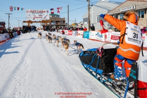 Last place finisher and Red Lantern Award winner Cindy Abbott holds up the red lantern as she runs down the finish chute in Nome during the 2017 Iditarod on Saturday March 18, 2017.Photo by Jeff Schultz/SchultzPhoto.com  (C) 2017  ALL RIGHTS RESERVED