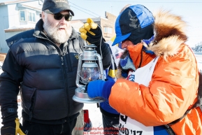 Race Marshal Mark Nordman with last place finisher and Red Lantern Award winner Cindy Abbott gives her the