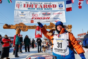 Last place finisher and Red Lantern Award winner Cindy Abbott holds up the red lantern after her finish in Nome during the 2017 Iditarod on Saturday March 18, 2017.Photo by Jeff Schultz/SchultzPhoto.com  (C) 2017  ALL RIGHTS RESERVED