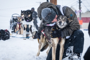 Jeff Deeter gives a big hug to one of his dog team after crossing the finish line of the Iditarod on March 18, 2020.