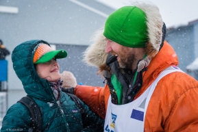 Kelly Maixner greats his wife with a smile after completing the Iditarod on March 18, 2020.