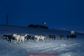 Martin Buser runs down the shore of the Bering Sea a mile from the finish line in Nome on Thursday March 19, 2015 during Iditarod 2015.  (C) Jeff Schultz/SchultzPhoto.com - ALL RIGHTS RESERVED DUPLICATION  PROHIBITED  WITHOUT  PERMISSION