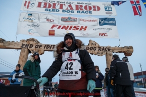 Richie Diehl poses for a photo after his finish at the burl arch in Nome on Thursday March 19, 2015 during Iditarod 2015.  (C) Jeff Schultz/SchultzPhoto.com - ALL RIGHTS RESERVED DUPLICATION  PROHIBITED  WITHOUT  PERMISSION