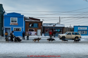 Spectators welcome Nathan Schroeder to Nome as he runs down Front Street on his way toward the finish line in Nome on Thursday March 19, 2015 during Iditarod 2015.  (C) Jeff Schultz/SchultzPhoto.com - ALL RIGHTS RESERVED DUPLICATION  PROHIBITED  WITHOUT  PERMISSION