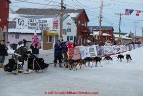 Nathan Schroeder runs into the finish chute toward the finish line in Nome on Thursday March 19, 2015 during Iditarod 2015.  (C) Jeff Schultz/SchultzPhoto.com - ALL RIGHTS RESERVED DUPLICATION  PROHIBITED  WITHOUT  PERMISSION