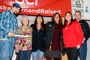 The Northern Air Cargo Herbie Nayokpuk Memorial Award is presented by Ross St. John, outside sales manager, and Cheryl Johnson, director of community relations for Northern Air Cargo as well as members of the Nayokpuk family including HerbieÂs widow Elizabeth to Michelle Phillips at the Nome Musher's Award Banquet during the 2017 Iditarod on Sunday March 19, 2017.Photo by Jeff Schultz/SchultzPhoto.com  (C) 2017  ALL RIGHTS RESERVED