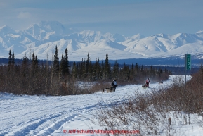 Jordan Seager, Andrew Noland and Katie Deits teams run down the trail on the Denali Highway with the Alaska Range in the background during the start day of the 2015 Junior Iditarod on Sunday March 1, 2015(C) Jeff Schultz/SchultzPhoto.com - ALL RIGHTS RESERVED DUPLICATION  PROHIBITED  WITHOUT  PERMISSION
