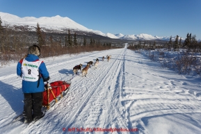 Marianna Mallory and team run down the trail on the Denali Highway with the Alaska Range in the background during the start day of the 2015 Junior Iditarod on Sunday March 1, 2015(C) Jeff Schultz/SchultzPhoto.com - ALL RIGHTS RESERVED DUPLICATION  PROHIBITED  WITHOUT  PERMISSION