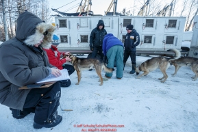 Volunteer veterinarians fill out paperwork on each and every dog as they are examined during the pre-race vet-check for dogs running this year's 2017 Iditarod at Iditarod Headquarters in Wasilla, Alaska.  Wednesday March 1, 2017Photo by Jeff Schultz/SchultzPhoto.com  (C) 2017  ALL RIGHTS RESVERVED
