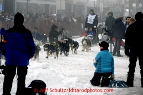 Nicholas Petit runs in the fog and amongst the spectators on 4th avenue during the ceremonial start of the Iditarod sled dog race Anchorage Saturday, March 2, 2013. Photo (C) Jeff Schultz/IditarodPhotos.com  Do not reproduce without permission