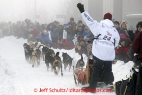 Fans watch aron Burmeister and team run down Cordova Street in the fog during the ceremonial start of the Iditarod sled dog race Anchorage Saturday, March 2, 2013. Photo (C) Jeff Schultz/IditarodPhotos.com  Do not reproduce without permission