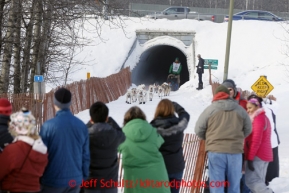 Fans line the bike/ski trail and watch Kelly Maxiner as he and his team run through a culvert during the ceremonial start of the Iditarod sled dog race Anchorage Saturday, March 2, 2013. Photo (C) Jeff Schultz/IditarodPhotos.com  Do not reproduce without permission