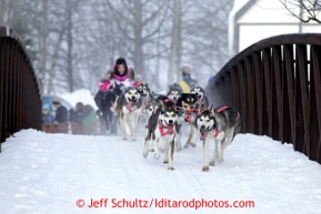 DeeDee Jonrowe runs over a bridge during the ceremonial start of the Iditarod sled dog race Anchorage Saturday, March 2, 2013. Photo (C) Jeff Schultz/IditarodPhotos.com  Do not reproduce without permission