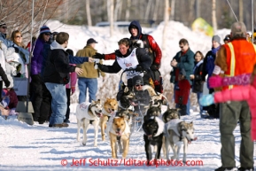 Cindy Abbott grabs a hot dog from the Horizon Lines checkpoint on the bike/ski trail during the ceremonial start of the Iditarod sled dog race Anchorage Saturday, March 2, 2013. Photo (C) Jeff Schultz/IditarodPhotos.com  Do not reproduce without permission