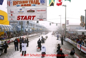 Peter Kaiser leaves the start line during the ceremonial start of the Iditarod sled dog race in downtown Anchorage Saturday, March 2, 2013. Photo (C) Jeff Schultz/IditarodPhotos.com  Do not reproduce without permission