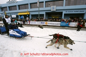 John Baker runs down 4th avenue during the ceremonial start of the Iditarod sled dog race in downtown Anchorage Saturday, March 2, 2013. Photo (C) Jeff Schultz/IditarodPhotos.com  Do not reproduce without permission