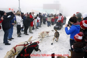 Iditarod champion Dallas Seavey runs past spectaors at the A street crossing on 4th avenue during the ceremonial start of the Iditarod sled dog race Anchorage Saturday, March 2, 2013. Photo (C) Jeff Schultz/IditarodPhotos.com  Do not reproduce without permission