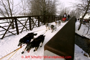 Anna Berington runs across the Chester Creek Bridge on the bike/ski trail during the ceremonial start of the Iditarod sled dog race Anchorage Saturday, March 2, 2013. Photo (C) Jeff Schultz/IditarodPhotos.com  Do not reproduce without permission