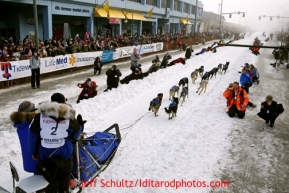 Martin Buser runs down 4th avenue at the ceremonial start of the Iditarod sled dog race in downtown Anchorage Saturday, March 2, 2013. Photo (C) Jeff Schultz/IditarodPhotos.com  Do not reproduce without permission