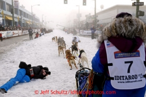 Michelle Phillips leaves the start line on 4th avenue in the fog during the ceremonial start of the Iditarod sled dog race in downtown Anchorage Saturday, March 2, 2013. Photo (C) Jeff Schultz/IditarodPhotos.com  Do not reproduce without permission