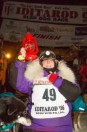 Mary Helwig at the Nome finish line finishes last to claim the red lantern award and was the one to extinquish the Widow's lamp during the 2016 Iditarod.  Alaska    

Photo by Jeff Schultz (C) 2016  ALL RIGHTS RESERVED