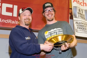 Aaron Burmeister, Official Finisher's Club president
presents Brent Sass with the First Musher to Ophir Award at the musher finisher's banquet in Nome during the 2016 Iditarod.  Alaska    

Photo by Jeff Schultz (C) 2016  ALL RIGHTS RESERVED