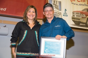 The Bristol Bay Native Corporation Fish First Award
is presented by Andria Agli, vice president, shareholder and corporate relations for Bristol Bay Native Corporation to
Mitch Seavey at the musher finisher's banquet in Nome during the 2016 Iditarod.  Alaska    

Photo by Jeff Schultz (C) 2016  ALL RIGHTS RESERVED