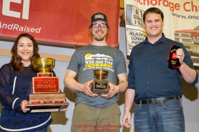 The Wells Fargo Gold Coast Award is presented by Jake Slingsby, vice president & senior business relations manager for Wells Fargo, and Callie King, operations supervisor for the Nome Wells Fargo branch to Brent Sass at the musher finisher's banquet in Nome during the 2016 Iditarod.  Alaska    

Photo by Jeff Schultz (C) 2016  ALL RIGHTS RESERVED