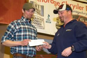 The Most Inspirational Musher Award is presented by Aaron Burmeister, IOFC President to Matt Failor at the musher finisher's banquet in Nome during the 2016 Iditarod.  Alaska    

Photo by Jeff Schultz (C) 2016  ALL RIGHTS RESERVED