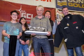 The Northern Air Cargo Herbie Nayokpuk Memorial Award
is presented by Cheryl Johnson and J.J. Harrier with Northern Air Cargo along with relatives of Herbie's to Ralph Johannessen at the musher finisher's banquet in Nome during the 2016 Iditarod.  Alaska    

Photo by Jeff Schultz (C) 2016  ALL RIGHTS RESERVED