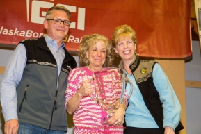DeeDee Jonrowe is re-presented a replica of the 1991 Alaska Airlines Leonhard Seppala award after it was lost in the Sockeye Fire by Marilyn Romano, regional vice president,  and Tim Thompson, manager, external affairs, with Alaska Airlinesat the musher finisher's banquet in Nome during the 2016 Iditarod.  Alaska    

Photo by Jeff Schultz (C) 2016  ALL RIGHTS RESERVED