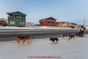 Becca Moore runs down Front Street as residents cheer her on a mile or so from the finsih line in Nome on Saturday March 21, 2015 during Iditarod 2015.  (C) Jeff Schultz/SchultzPhoto.com - ALL RIGHTS RESERVED DUPLICATION  PROHIBITED  WITHOUT  PERMISSION