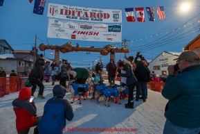 A crowd gathers around Alan Eischens in the finish chute in Nome shortly afer he arrived on Saturday March 21, 2015 during Iditarod 2015.  (C) Jeff Schultz/SchultzPhoto.com - ALL RIGHTS RESERVED DUPLICATION  PROHIBITED  WITHOUT  PERMISSION