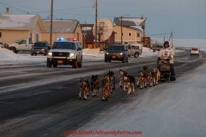 Steve Watkins runs down Front Street on his way to the finish line in Nome on Saturday March 21, 2015 during Iditarod 2015.  (C) Jeff Schultz/SchultzPhoto.com - ALL RIGHTS RESERVED DUPLICATION  PROHIBITED  WITHOUT  PERMISSION
