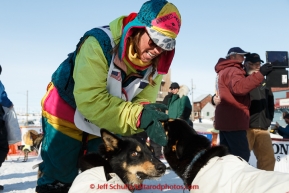 Monica Zappa Congratulates her dogs at the finish line in Nome on Saturday March 21, 2015 during Iditarod 2015.  (C) Jeff Schultz/SchultzPhoto.com - ALL RIGHTS RESERVED DUPLICATION  PROHIBITED  WITHOUT  PERMISSION
