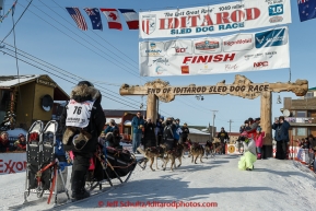 Heidi Sutter runs into the chute at the finish line in Nome on Saturday March 21, 2015 during Iditarod 2015.  (C) Jeff Schultz/SchultzPhoto.com - ALL RIGHTS RESERVED DUPLICATION  PROHIBITED  WITHOUT  PERMISSION