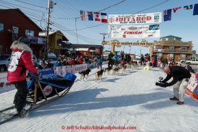 Lisbet Norris runs into the chute and across the finish line in Nome on Saturday March 21, 2015 during Iditarod 2015.  (C) Jeff Schultz/SchultzPhoto.com - ALL RIGHTS RESERVED DUPLICATION  PROHIBITED  WITHOUT  PERMISSION