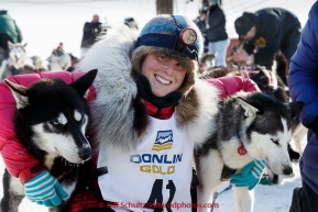 Lisbet Norris poses with her lead dogs at the finish line in Nome on Saturday March 21, 2015 during Iditarod 2015.  (C) Jeff Schultz/SchultzPhoto.com - ALL RIGHTS RESERVED DUPLICATION  PROHIBITED  WITHOUT  PERMISSION