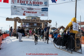 Alan Stevens runs across the finish line in Nome on Saturday March 21, 2015 during Iditarod 2015.  (C) Jeff Schultz/SchultzPhoto.com - ALL RIGHTS RESERVED DUPLICATION  PROHIBITED  WITHOUT  PERMISSION