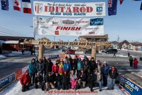 A portion of the mushers who finished the 2015 Iditarod as of 2pm on Saturday March 21st pose at the finish line in Nome for a group photo(C) Jeff Schultz/SchultzPhoto.com - ALL RIGHTS RESERVED DUPLICATION  PROHIBITED  WITHOUT  PERMISSION