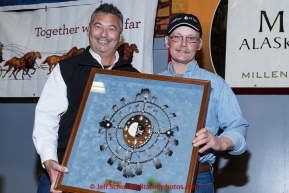 Mitch Seavey (L) recieves the PenAir Spirit of Alaska award from Danny Seybert of PenAir at the finishers banquet in Nome on Sunday  March 22, 2015 during Iditarod 2015.  (C) Jeff Schultz/SchultzPhoto.com - ALL RIGHTS RESERVED DUPLICATION  PROHIBITED  WITHOUT  PERMISSION