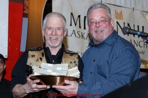 Jeff King (L) recieves the Millenium Hotel 1st musher to the Yukon award from Patrick Cashman at the finishers banquet in Nome on Sunday  March 22, 2015 during Iditarod 2015.  (C) Jeff Schultz/SchultzPhoto.com - ALL RIGHTS RESERVED DUPLICATION  PROHIBITED  WITHOUT  PERMISSION
